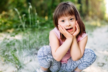 Portrait of young girl with down syndromeの写真素材