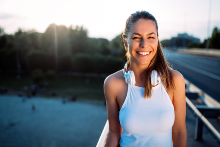 Portrait of woman taking break from joggingの写真素材