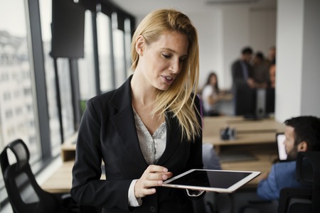 Portrait of beautiful blonde businesswoman holding tablet