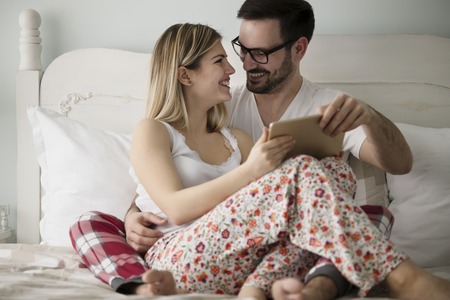 Attractive couple in love using digital tablet