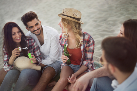 Group of cheerful friends having great time at beachの写真素材