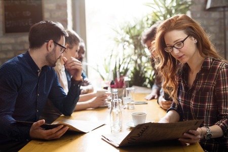 Happy colleagues from work socializing in restaurant