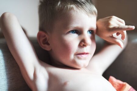 Portrait of cute little boy looking to distanceの写真素材