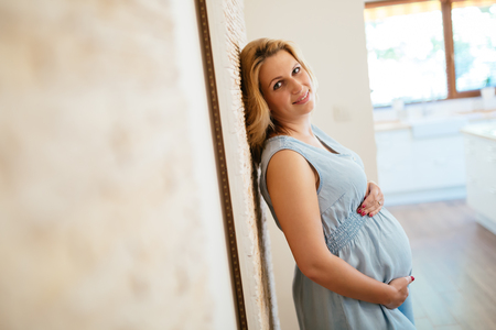Pregnant woman holding her bellyの写真素材