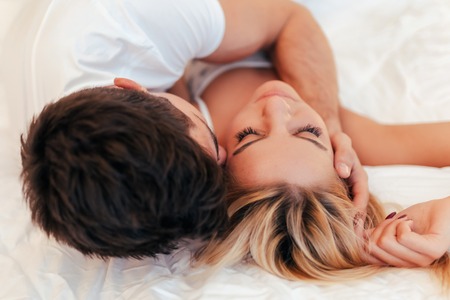 Happy couple in bedroomの写真素材