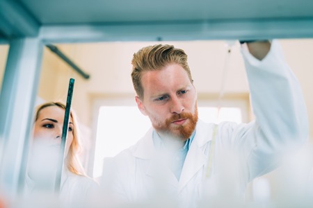 Young students of chemistry working in laboratoryの写真素材