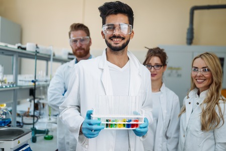 Group of young successful scientists posing for cameraの写真素材