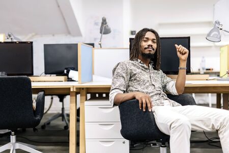 Handsome graphics designer sitting at a deskの写真素材