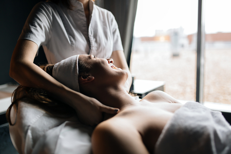 Beautiful woman enjoying massageの写真素材