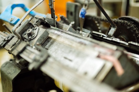 Old knitting machine in functionの写真素材