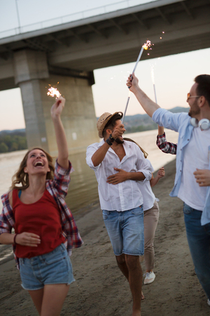 Group of happy friends having fun at beach in summerの写真素材