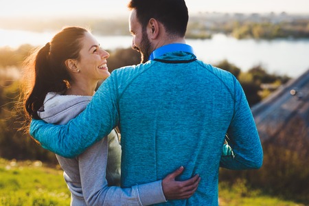 Happy young sporty couple sharing romantic moments