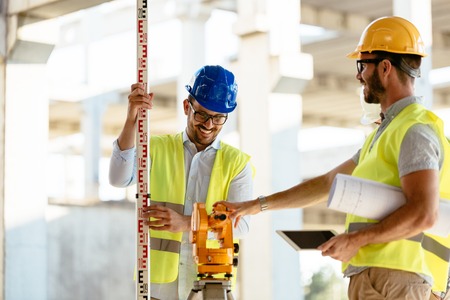 Portrait of construction engineers working on building site