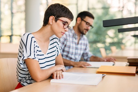 Portrait of young female student in library