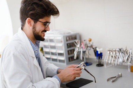 Optician repairing and fixing eye glasses