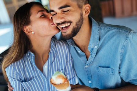 Happy couple having date and eating ice creamの写真素材