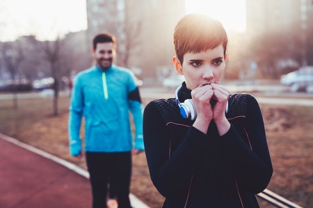 Woman fitness exercising in cold weather outdoorの写真素材