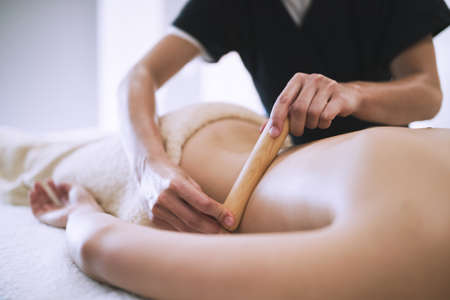 Masseur treating patient with therapeutic massageの写真素材