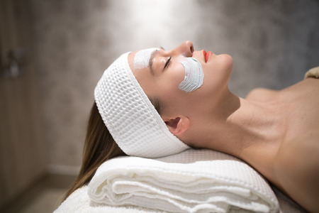 Beautiful woman relaxing on massage bedの写真素材