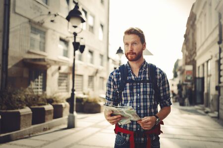 Tourist holding map and sightseeing in cityの写真素材