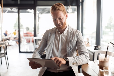 Businessman using tablet in cafeの写真素材
