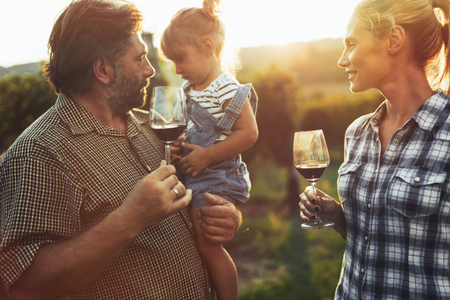 Winemaker family together in vineyardの写真素材