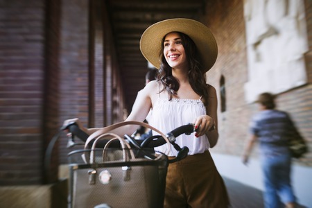 Portrait of beautiful young woman enjoying time on bicycleの写真素材
