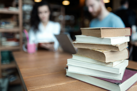 Portrait of students studying in bookstore togetherの写真素材