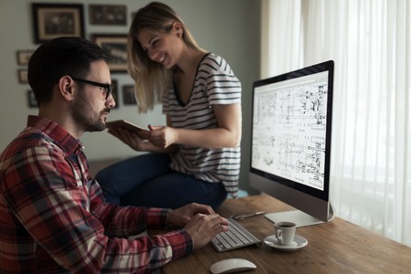 Young attractive designers working together from homeの写真素材