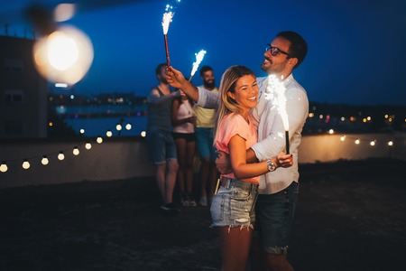Group of happy friends celebrating at rooftopの写真素材