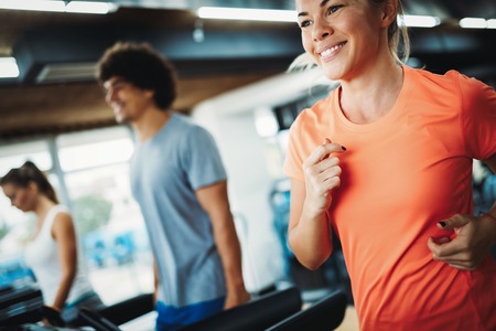 Young attractive woman doing cardio training in gym