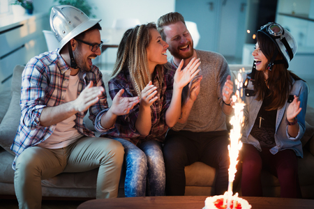 Group of friends enjoying and celebrating birthday and partyingの写真素材