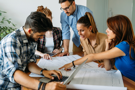 Image of business partners discussing documents and ideas