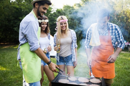 Friends spending time in nature and having barbecueの写真素材