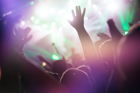 Cheering crowd at concert enjoying music performanceの写真素材