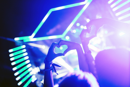 Portrait of happy crowd enjoying at music festivalの写真素材