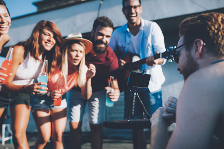Group of happy friends having party on rooftopの写真素材