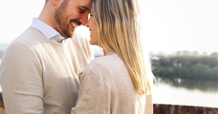 Happy couple in love hugging outdoorの写真素材