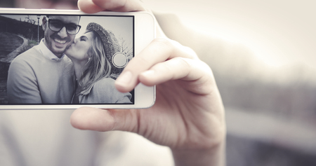 Couple in love taking selfies outdoorsの写真素材