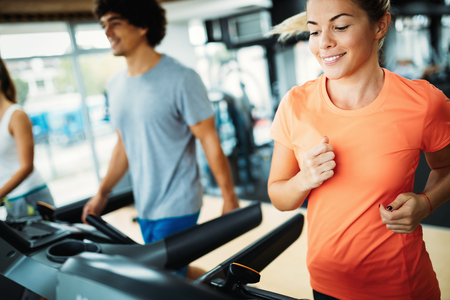 Young attractive woman doing cardio training in gymの写真素材
