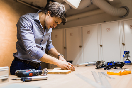 Joiner working and designing on workbenchの写真素材