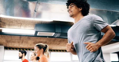 Young attractive woman doing cardio training in gym