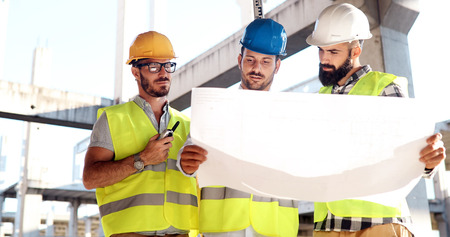 Portrait of construction engineers working on building site