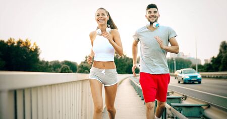 Attractive man and beautiful woman jogging together