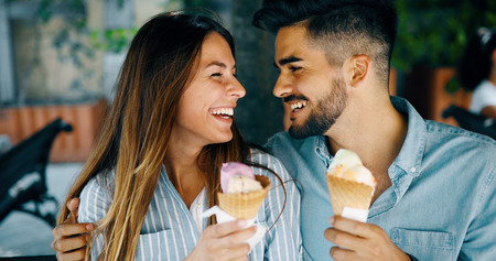 Happy couple having date and eating ice creamの写真素材