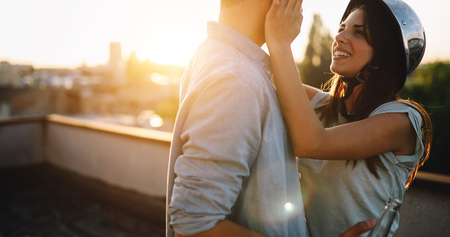 Young happy couple toasting with beer outdoorsの写真素材