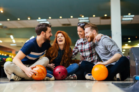 Cheerful friends bowling togetherの写真素材