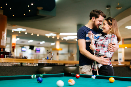 Happy couple playing snookerの写真素材
