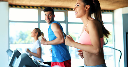 Picture of people running on treadmill in gymの写真素材