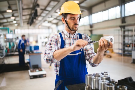 Male worker and quality control inspection in factoryの写真素材